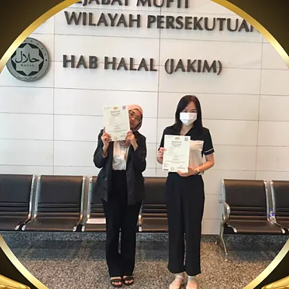 Two people from B&O Supply holding halal certificates