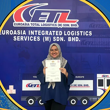 A member of the Euroasia Total Logistics team holding a halal certificate