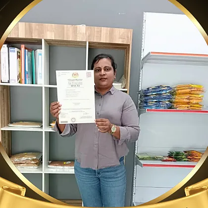 Puan Puranesuari of HD Spices Curry Product holding a halal certificate