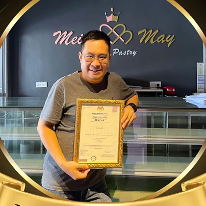 Mr. Choy of Mei & May holding a framed certificate