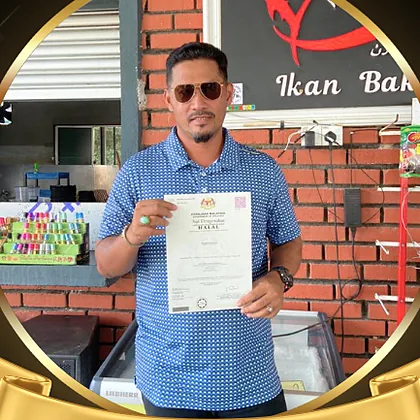 Encik Zamani holding a halal certificate