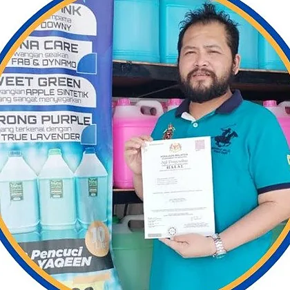 A man from Wealth Brothers Trading holding a halal certificate among cleaning products